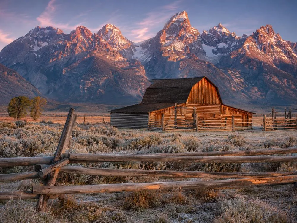 A homestead barn on Mormon Row with the Teton range behind it